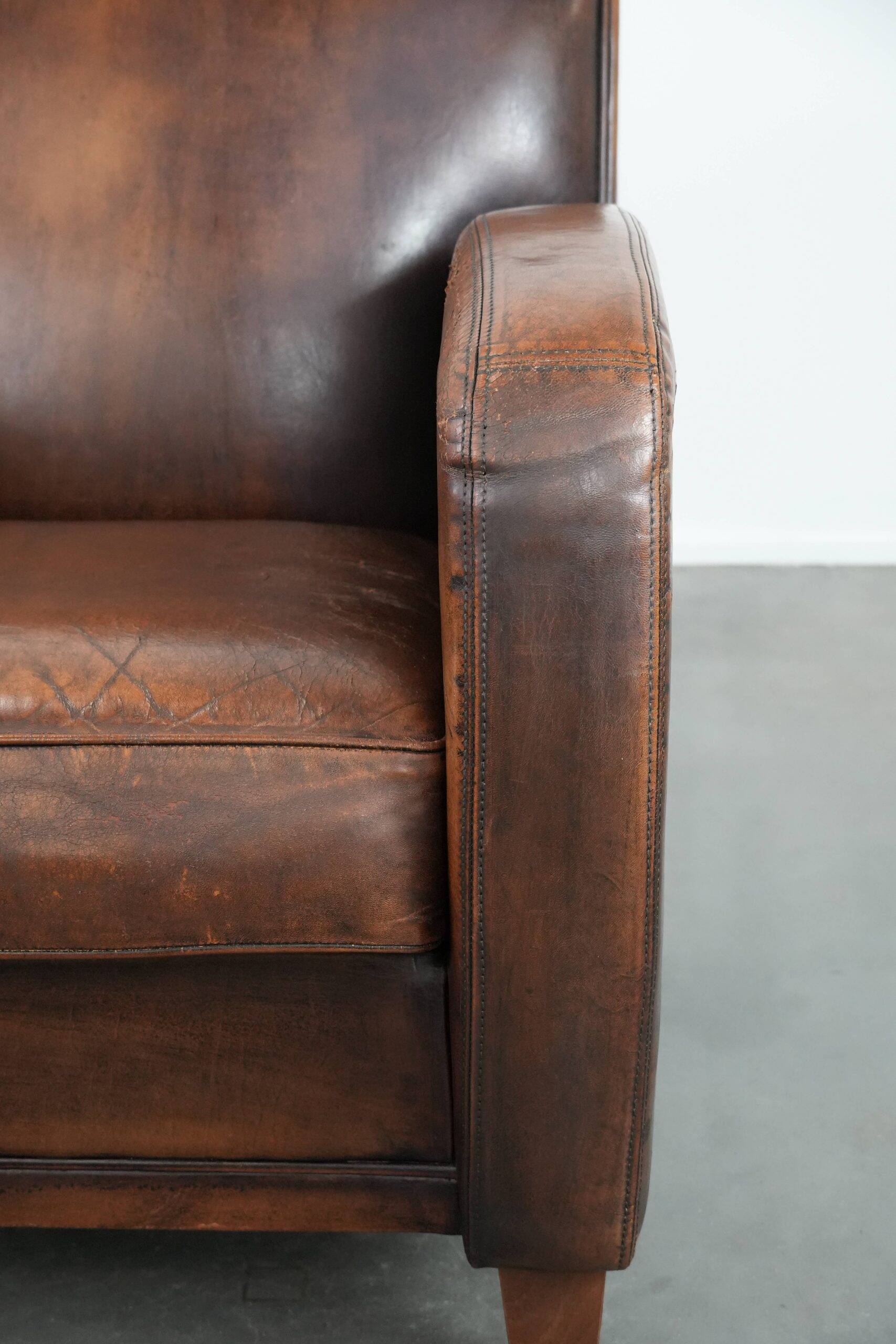 Beautifully shaped vintage sheepskin armchair with character