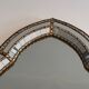 Mirror consisting of multi-faceted mirrors and brass garlands, French work, around 1970