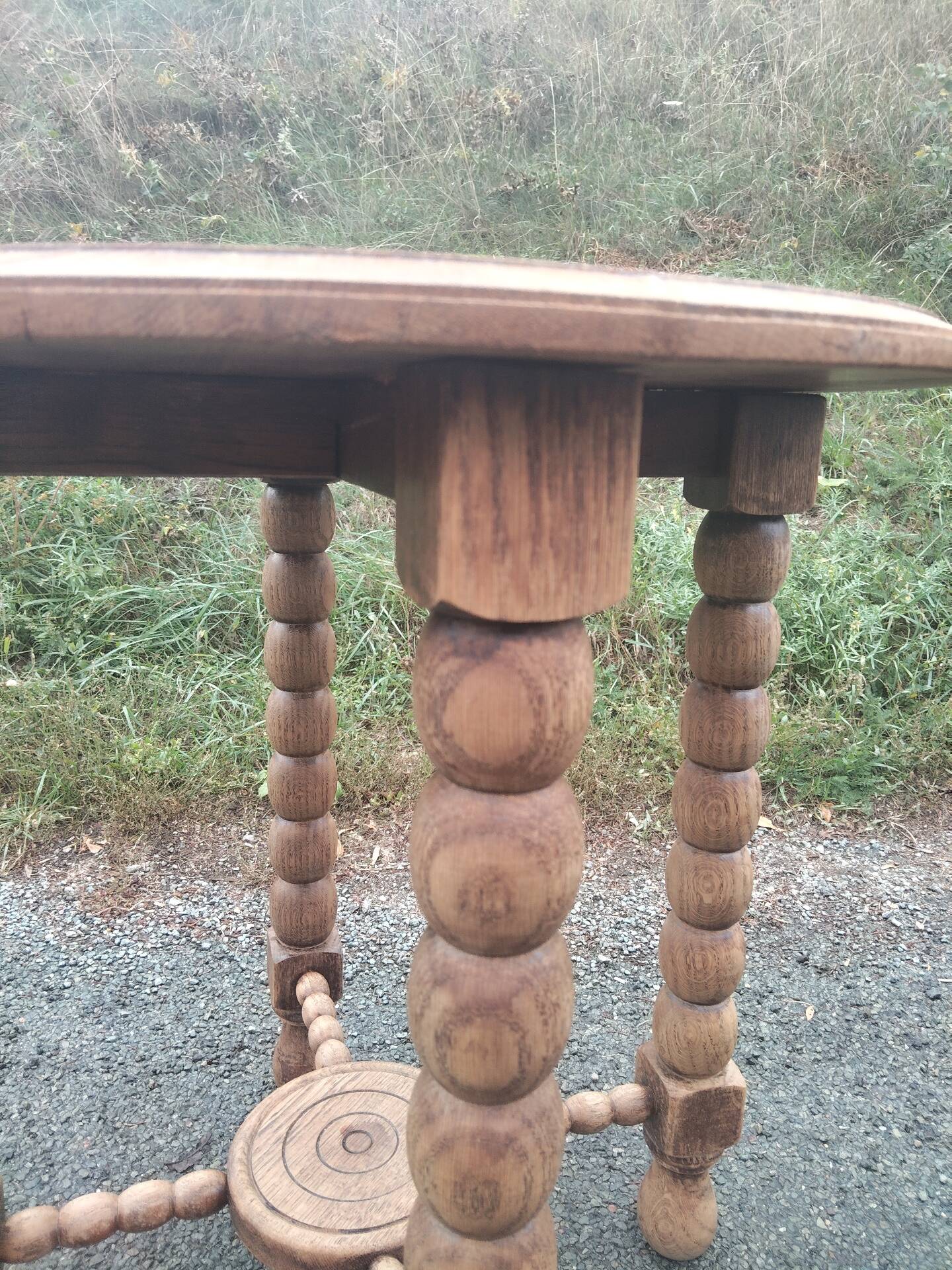 Oak gueridon in the style of Charles Dudouyt, 1940-50.