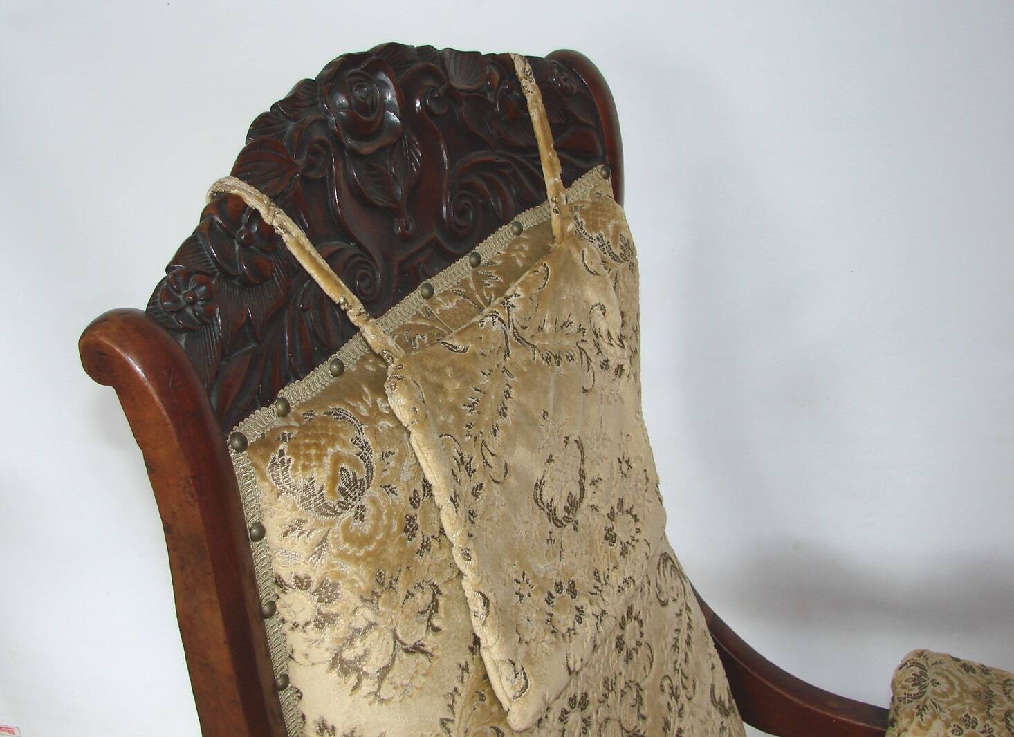 An antique armchair from the turn of the 19th and 20th centuries, carved wa