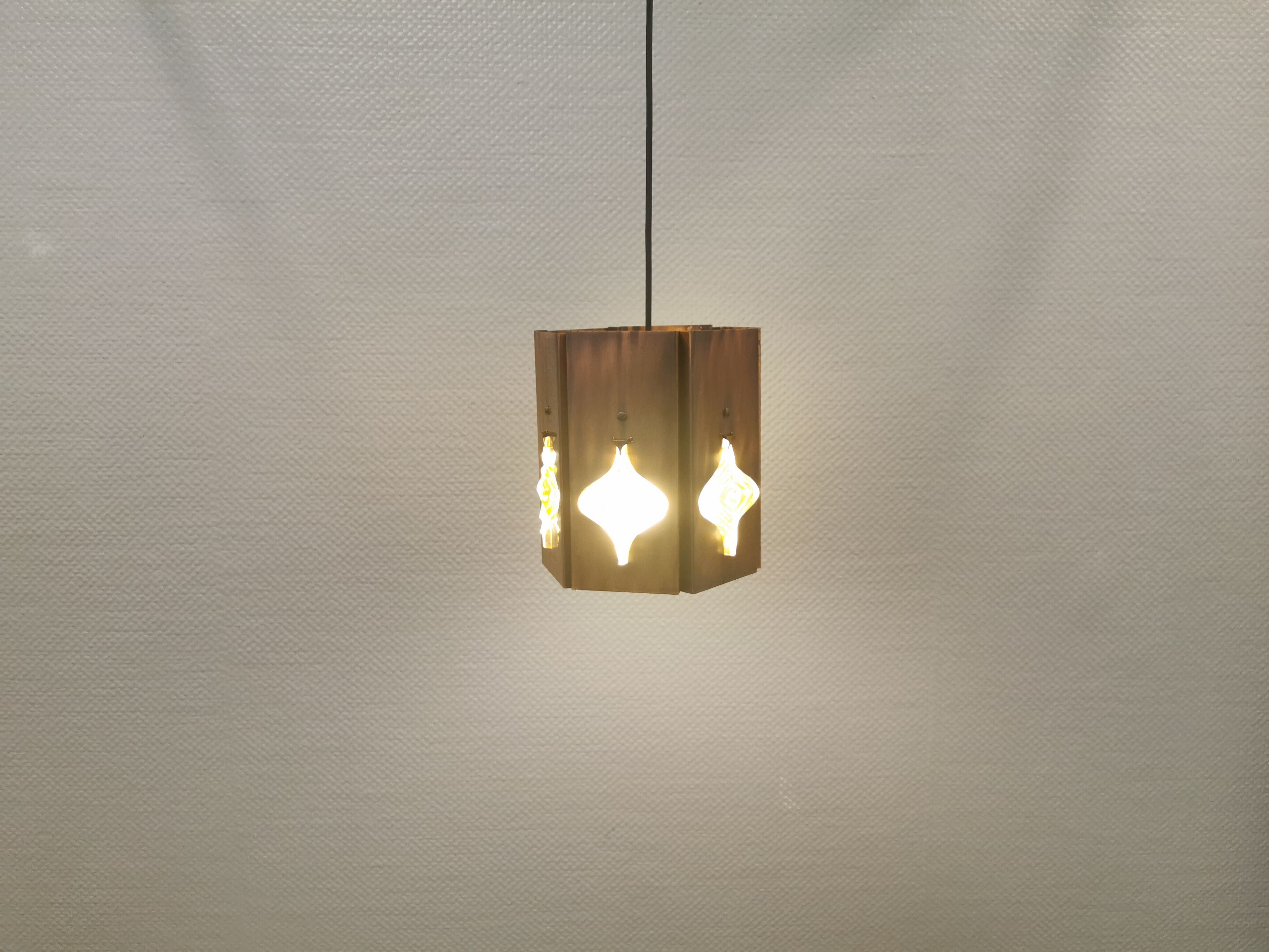 Older hanging lamp, made of metal with yellow prisms.