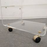 End of sofa with glass and plexiglass wheels from the 70s