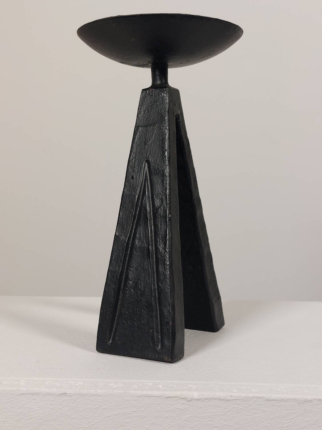 Vintage candle holder made of hand-forged metal, in a brutalist style.
