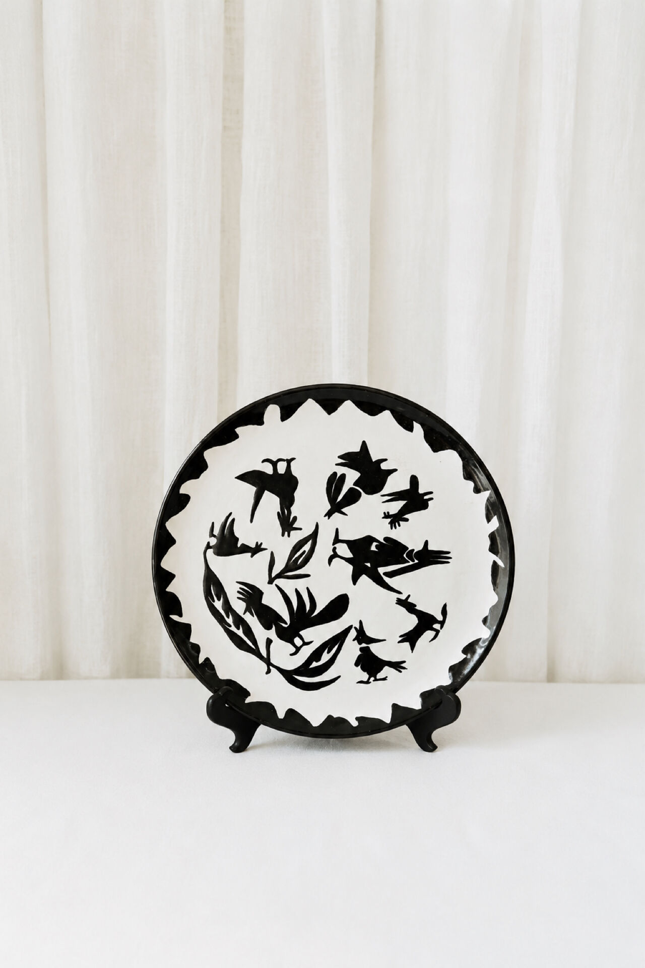 Large ceramic plate J. Lurçat with zoomorphic decoration in black on a white background.