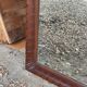 Large wall mirror with an elegant wooden frame.