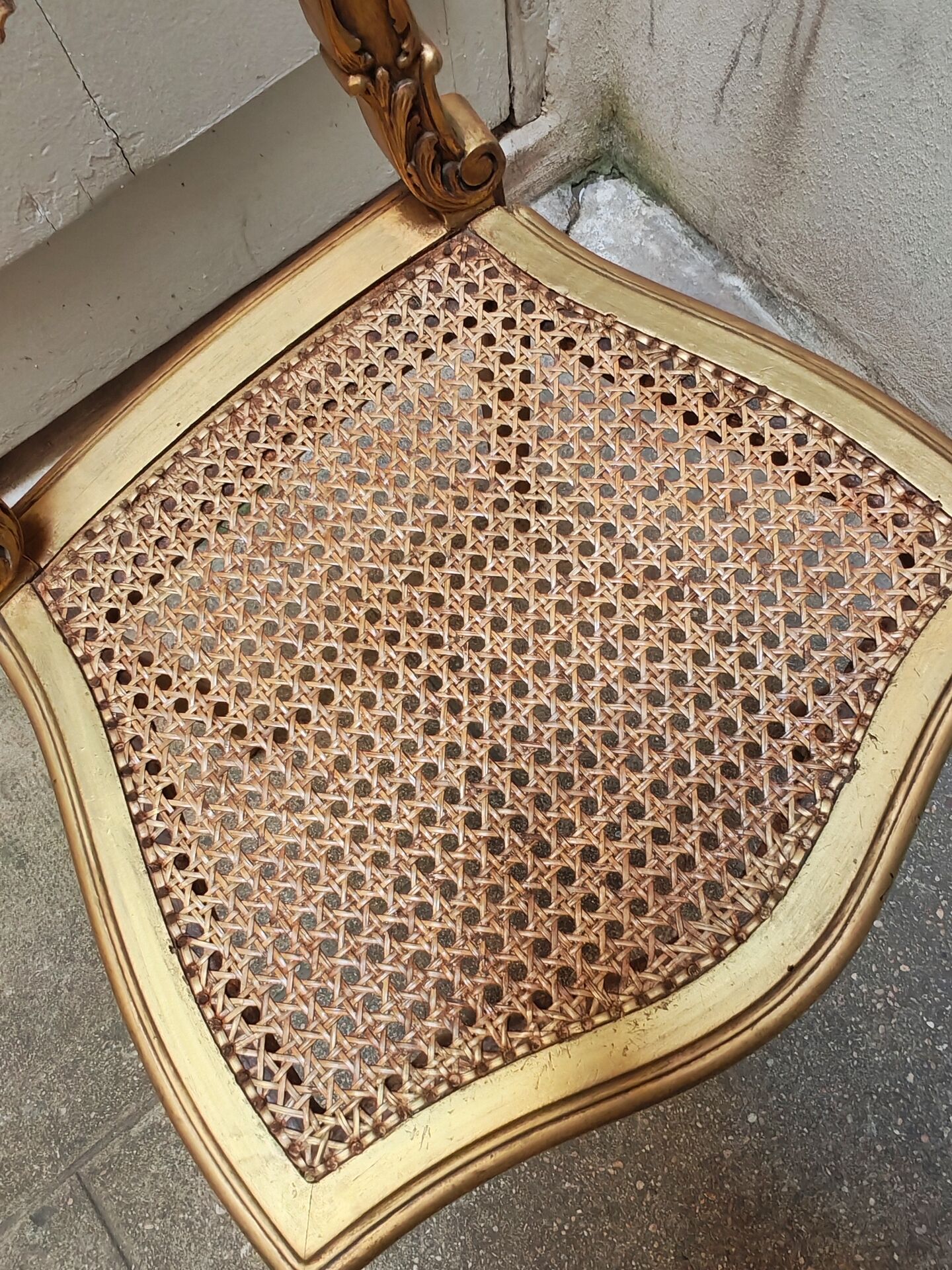 Antique rococo chair in gilded wood and caning