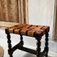 Antique turned wooden stool with woven leather.