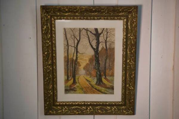 Lithograph of a woodland path, gilt frame, with embossed foliage decoration, 1950s