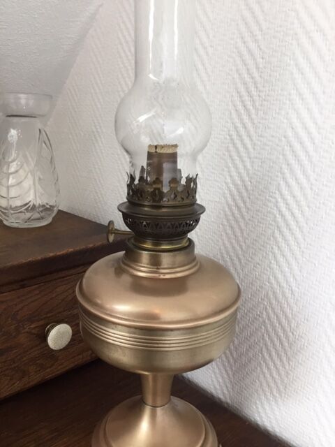 Old oil lamp on pink copper stand