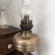 Old oil lamp on pink copper stand