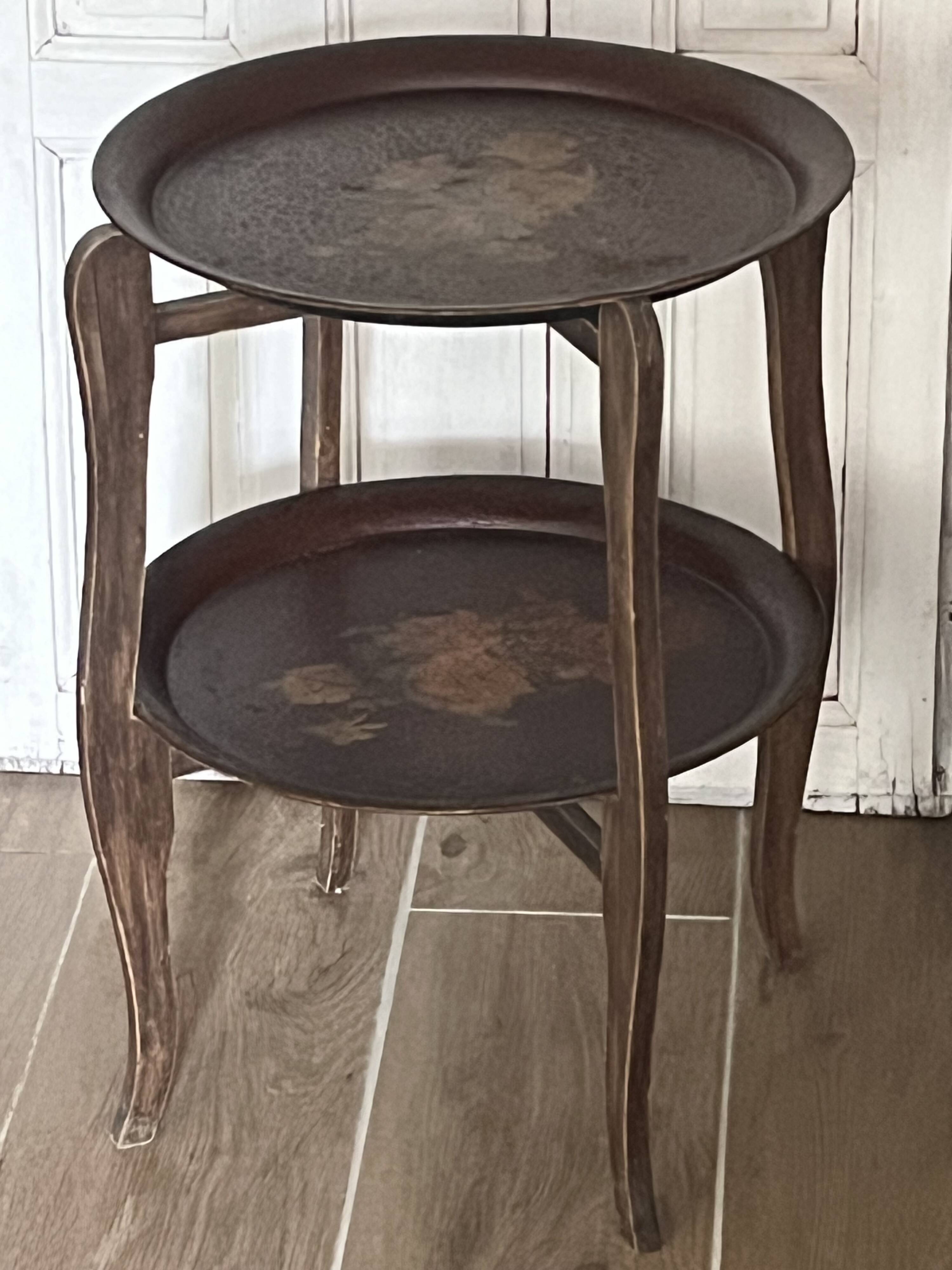 Two old trays on a stand/console.