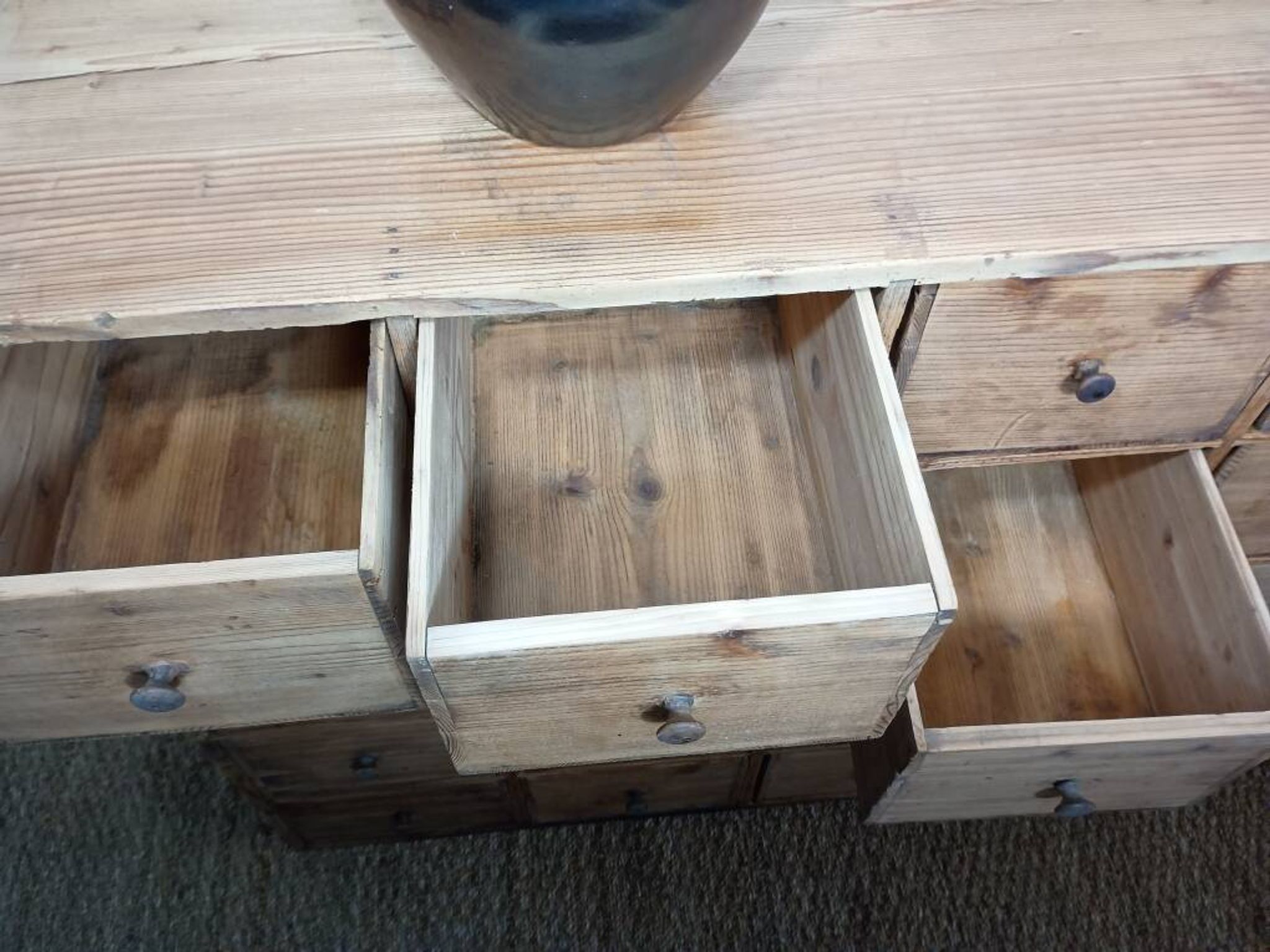 Industrial or apothecary workbench with 30 vintage wooden drawers.