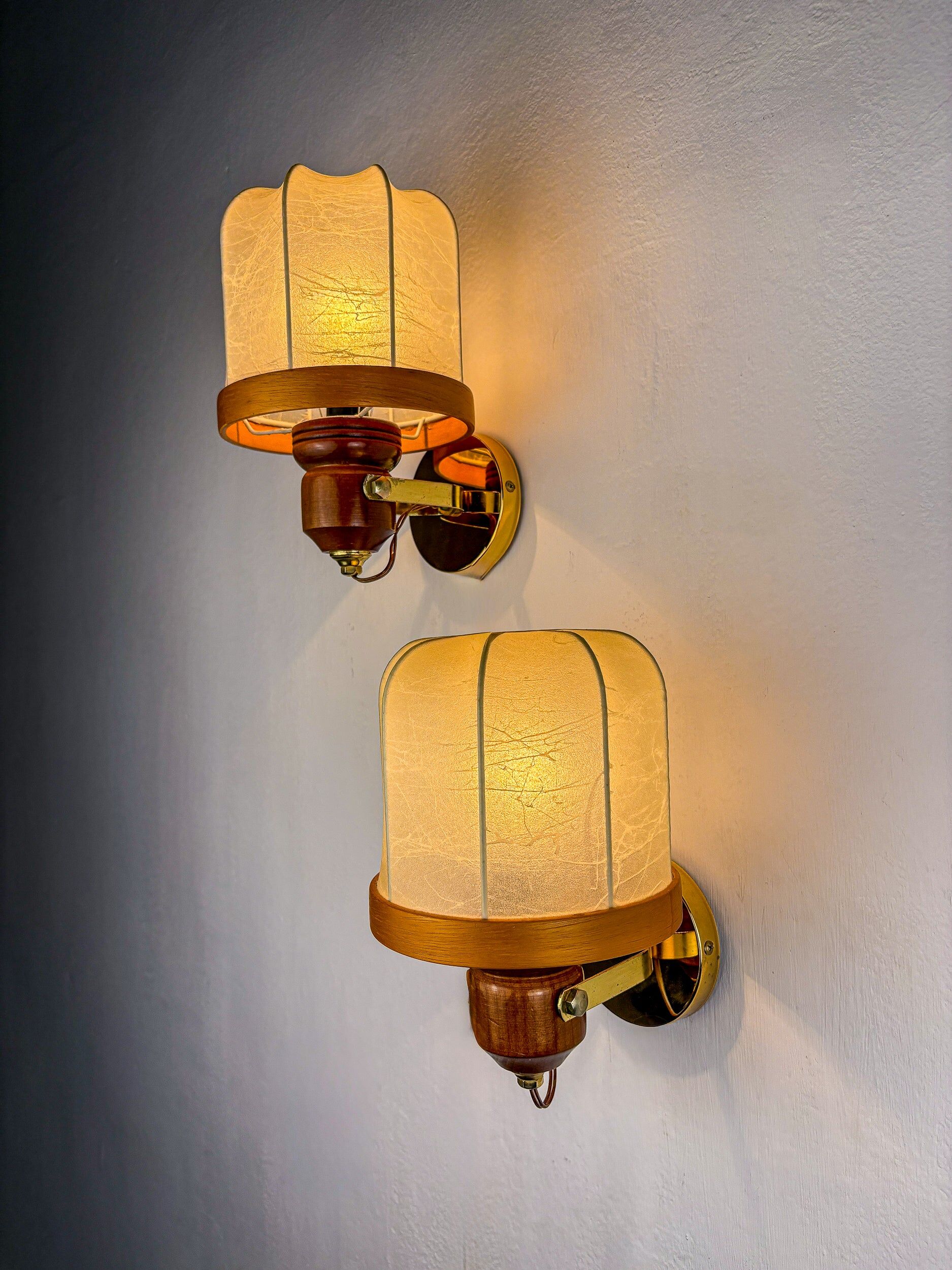 Pair of Italian articulated "Cocoon" wall lights, resin and pine, 1970s