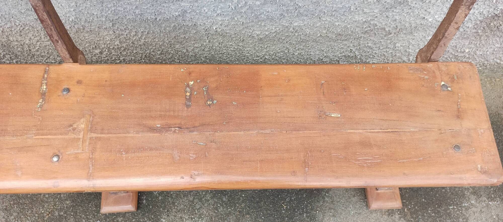 Old wooden bench with cast iron base