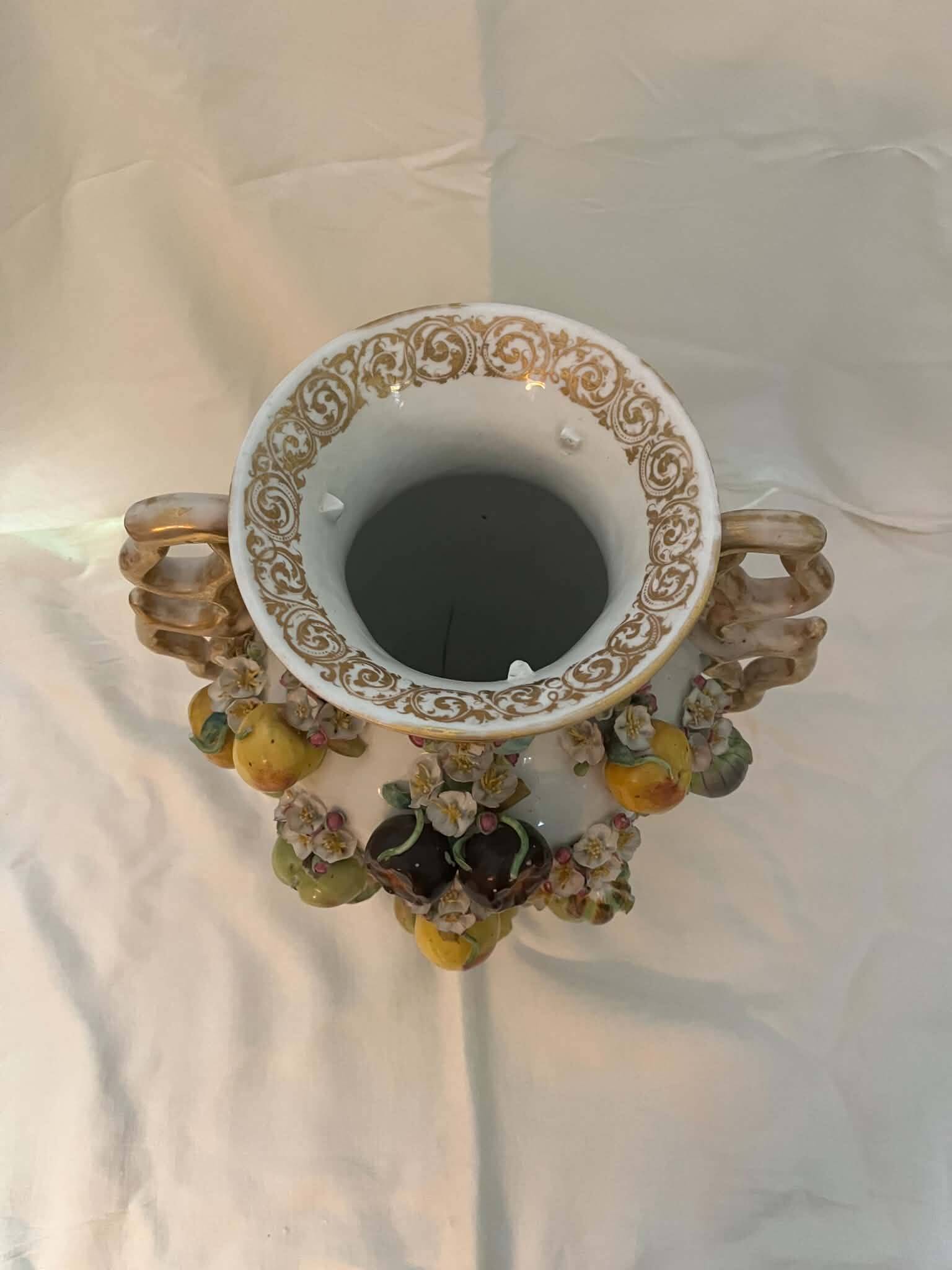 Large antique vase with relief decorations of coloured fruits.