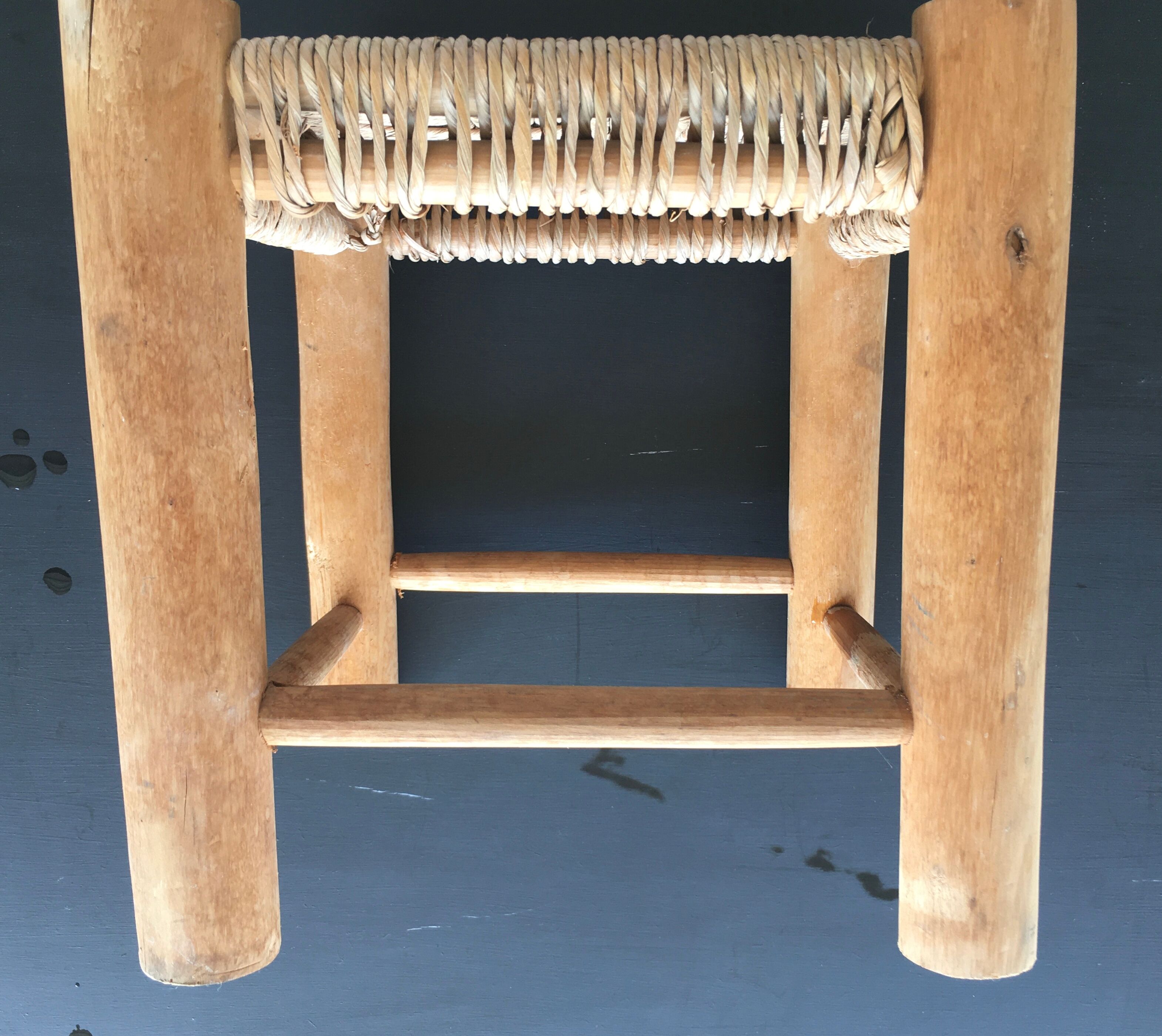 Wooden stool seated in braided rope