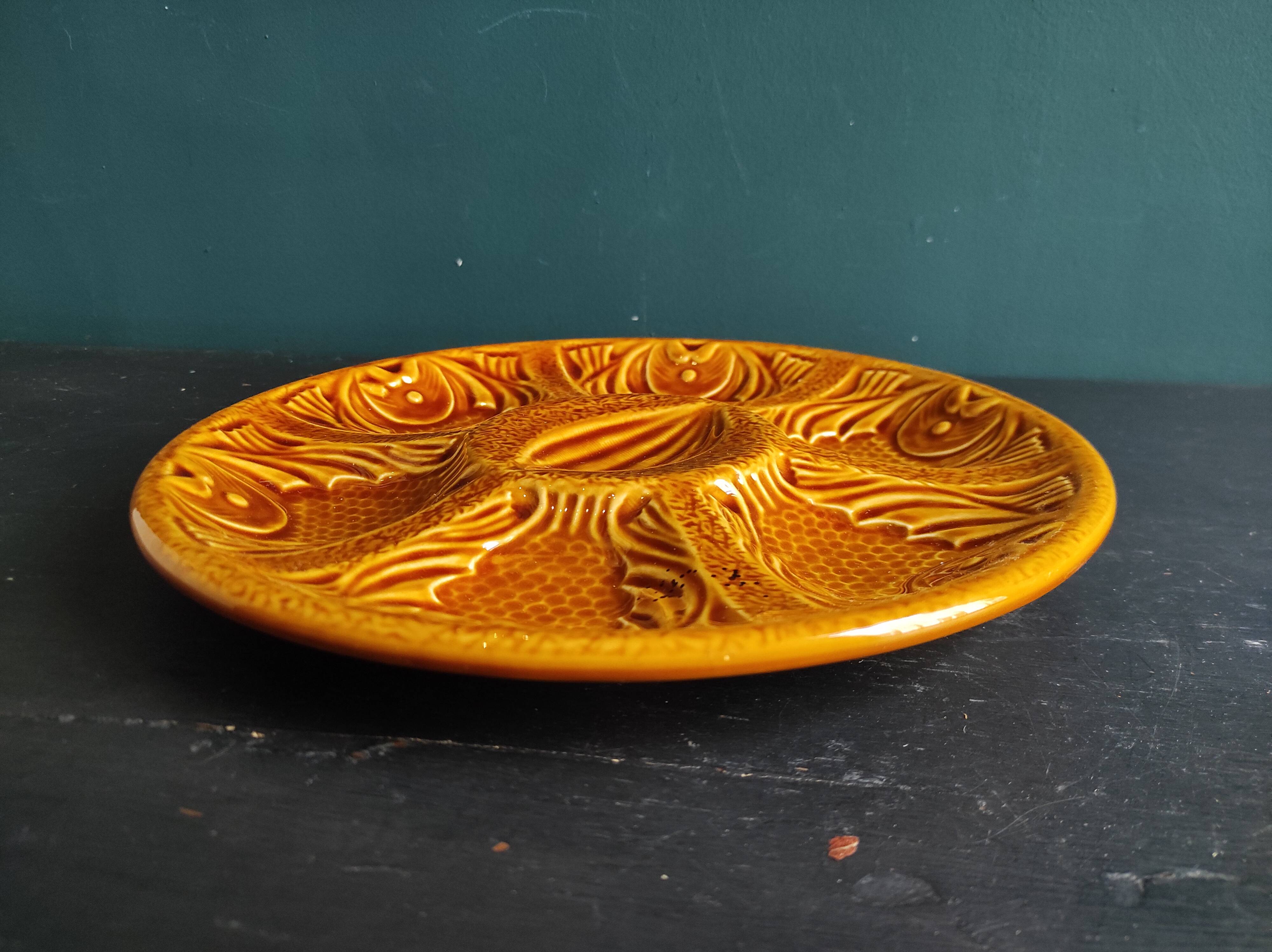 Vintage French amber oyster plate in Majolica decorated with fishes
