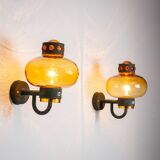 Pair of brass wall lamps with decorated amber coloured shades