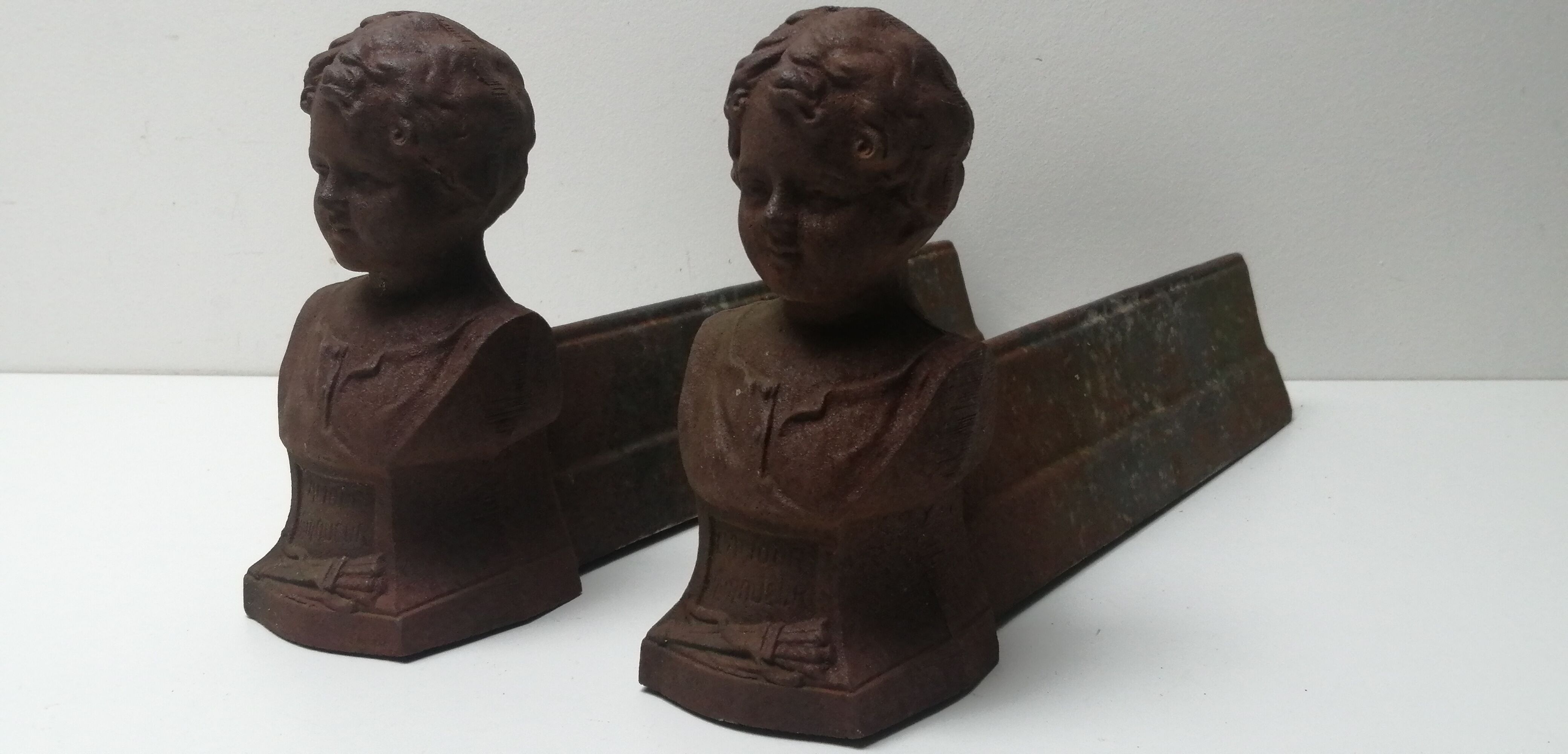 Pair of cast iron fireplace chenets "children"