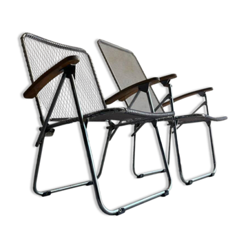 Pair of vintage silver aluminum wire folding chairs with wooden armrests — industrial minimalist