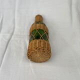 Green bottle with wicker decoration
