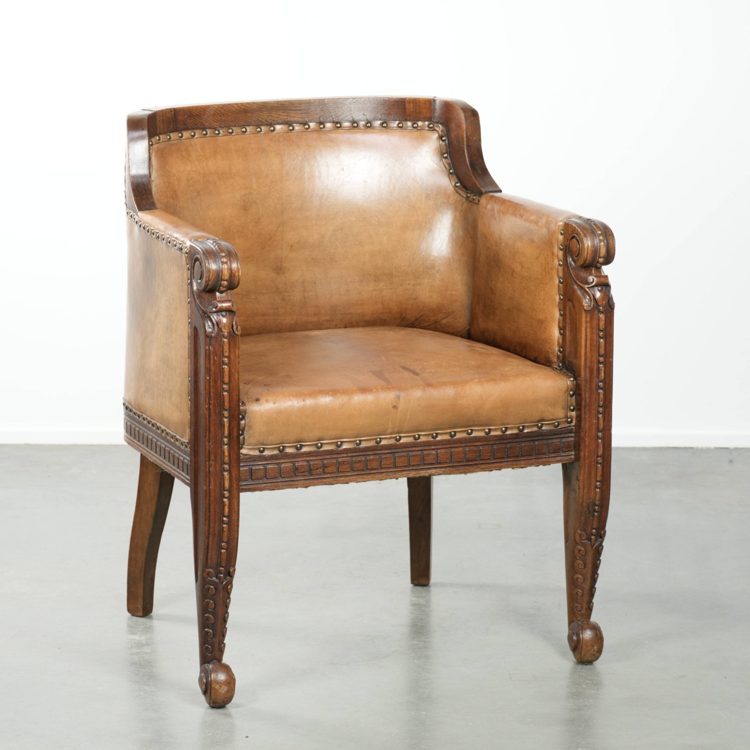 Antique armchair made of sheepskin and wood with decorative nails
