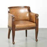 Antique armchair made of sheepskin and wood with decorative nails
