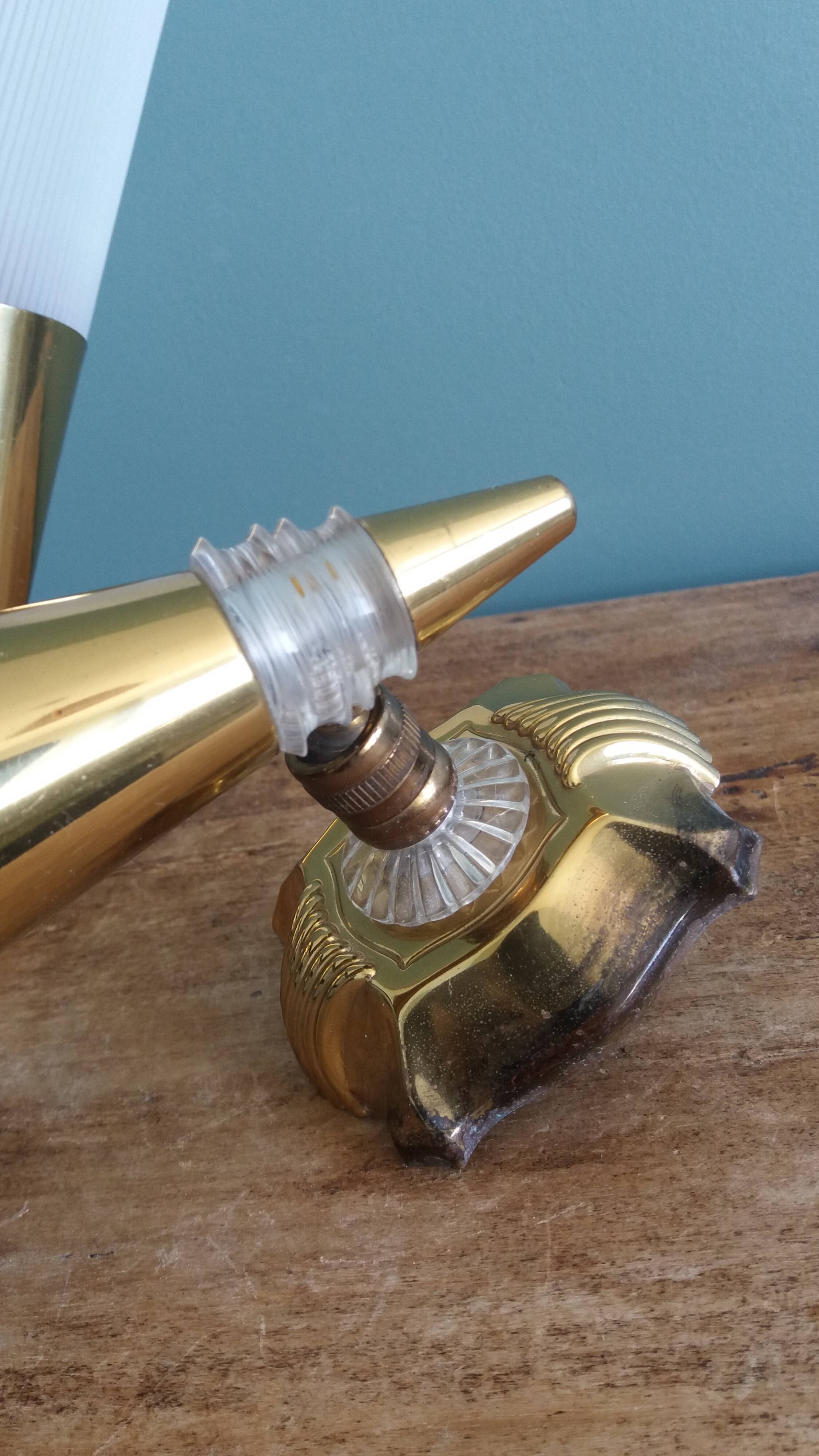 Brass and plexiglass wall lights in the Maison Lunel style.