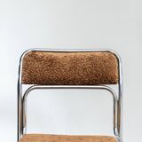 Chrome dining chair upholstered in brown bitten velvet.