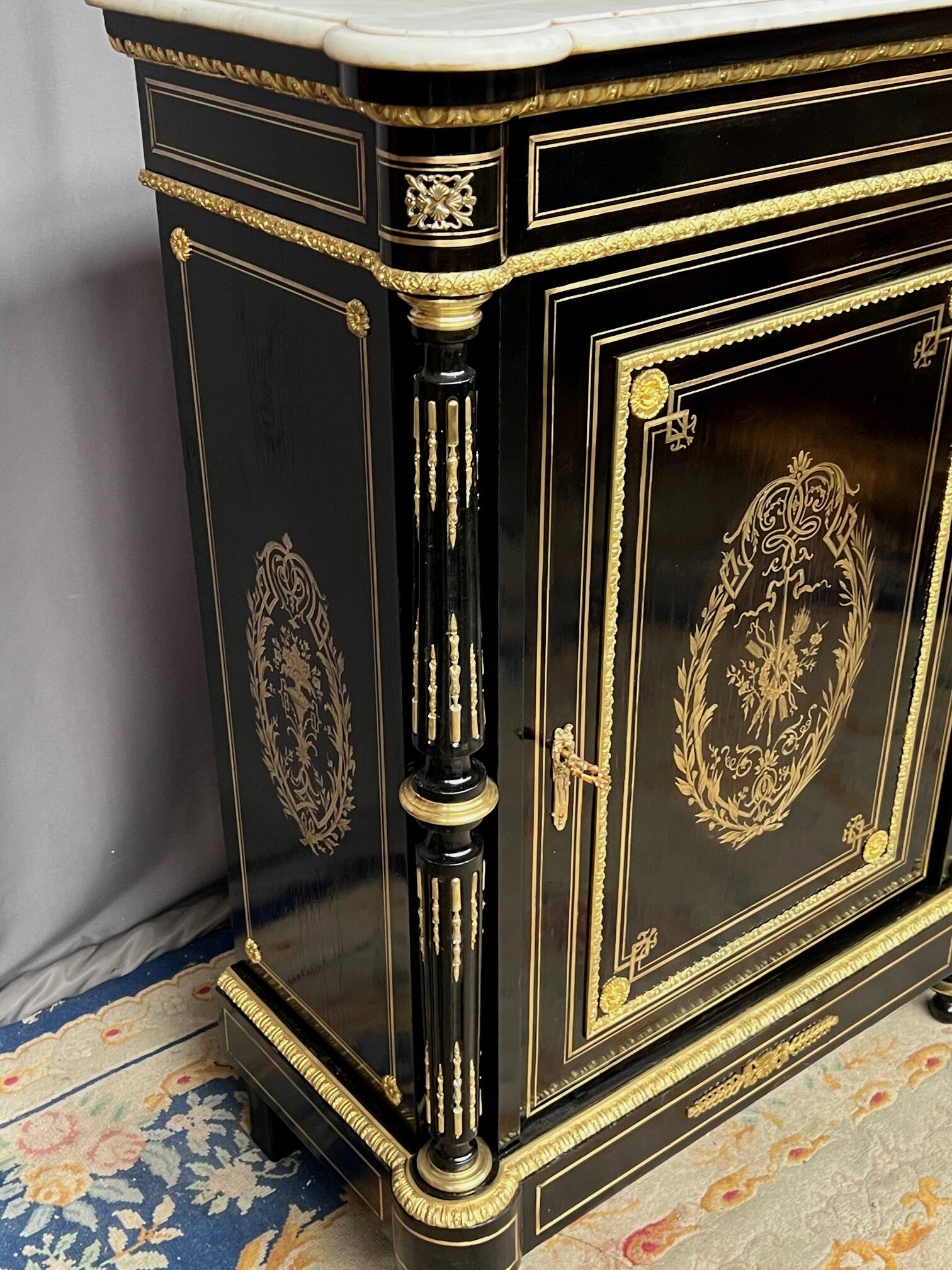 Napoleon III style commode, decorated with brass marquetry and gilded bronze mounts.