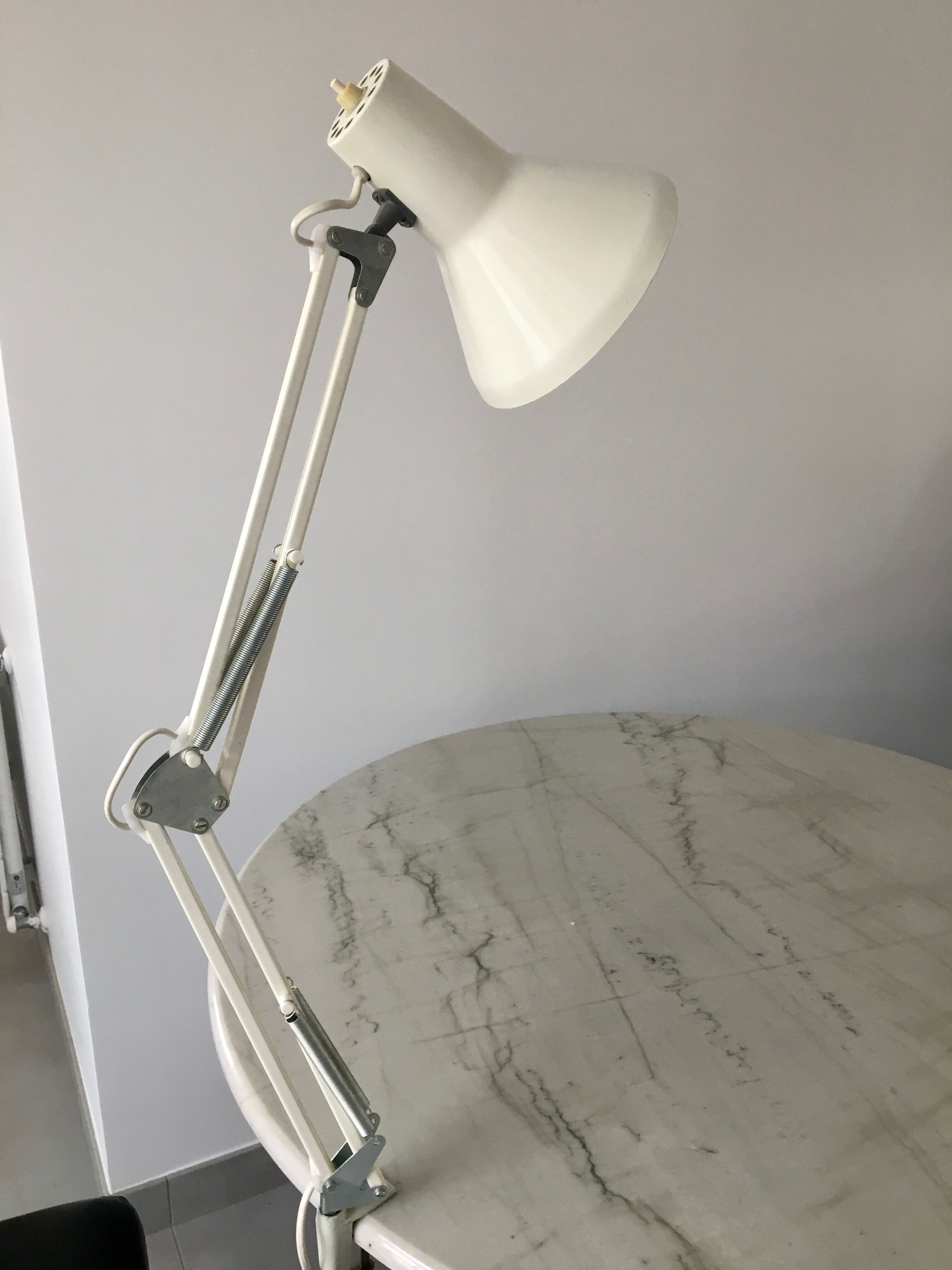Off-white articulated architect lamp.