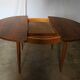 Round rosewood table with extension from the 70s