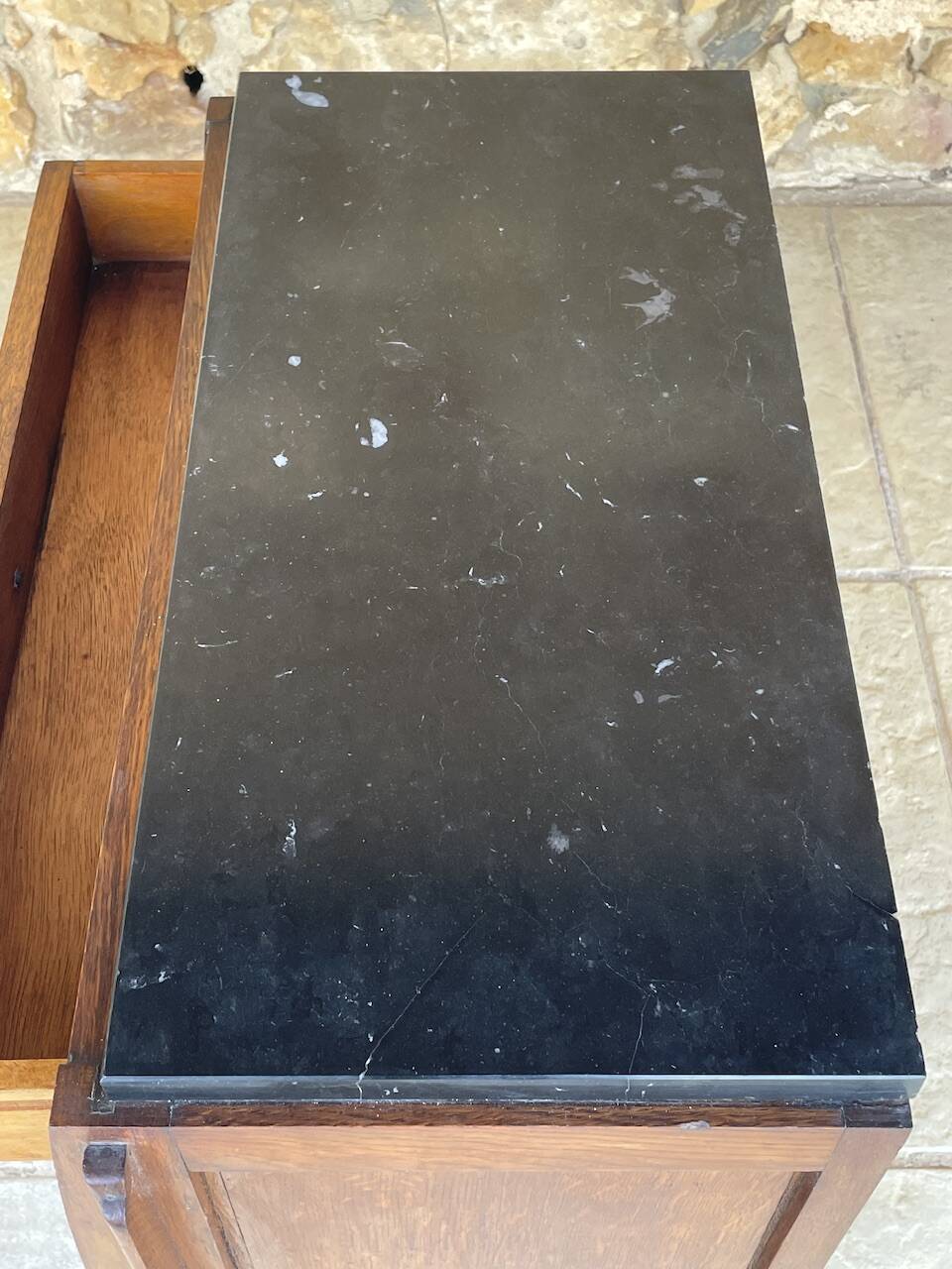 Art Deco bedside table in walnut, black marble top, circa 1920.