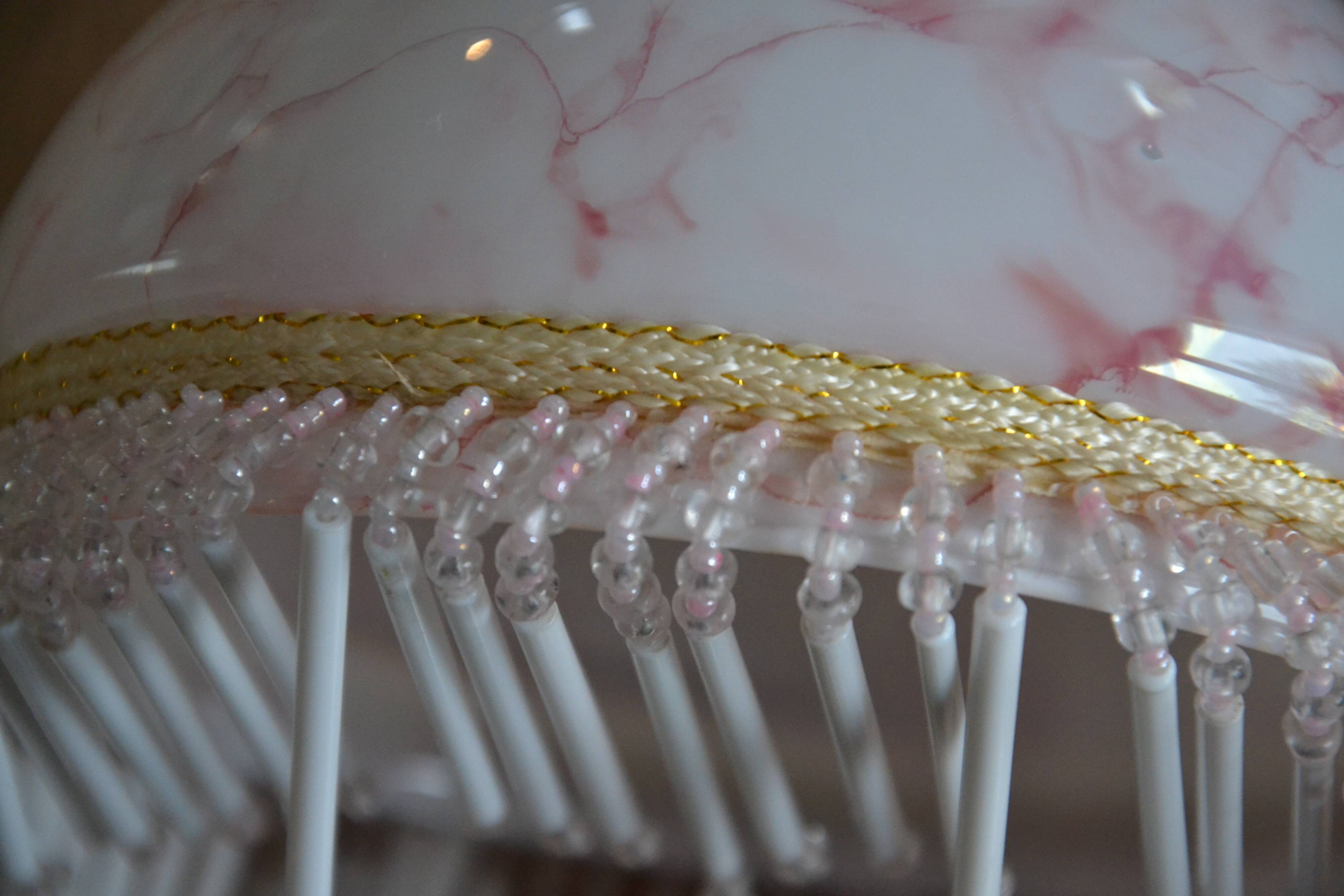 Lustrous suspension in glass paste, glass and ceramic pendants.