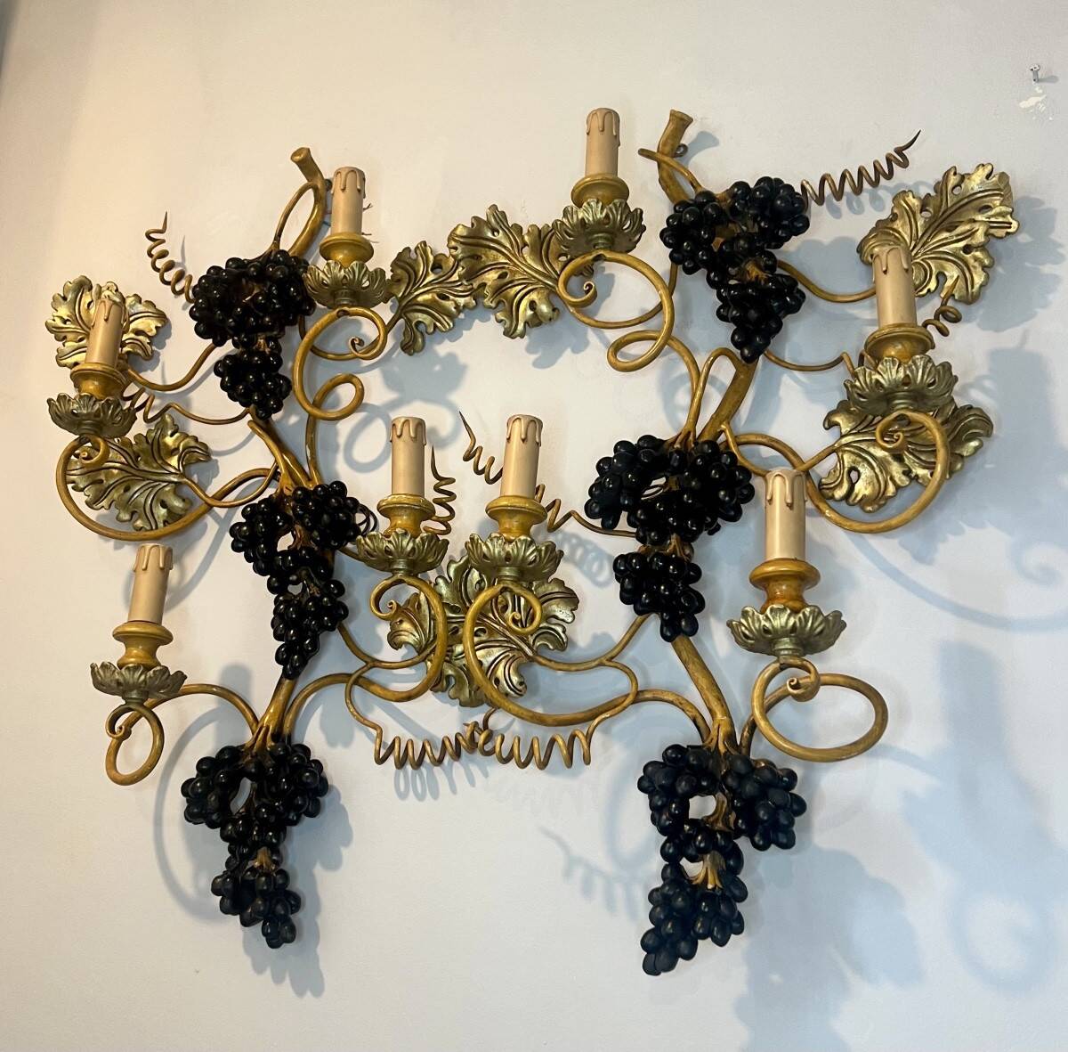 Large pair of wall sconces with vine decorations.