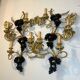 Large pair of wall sconces with vine decorations.