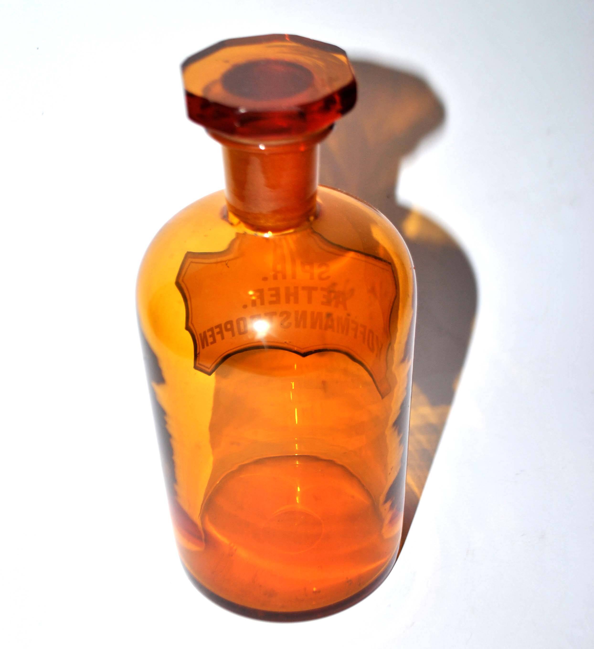 Old apothecary bottle Glass pharmacy bottle with enameled label