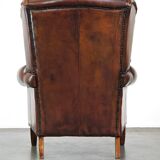Luxurious sheepskin armchair with a fixed seat cushion and high seating comfort
