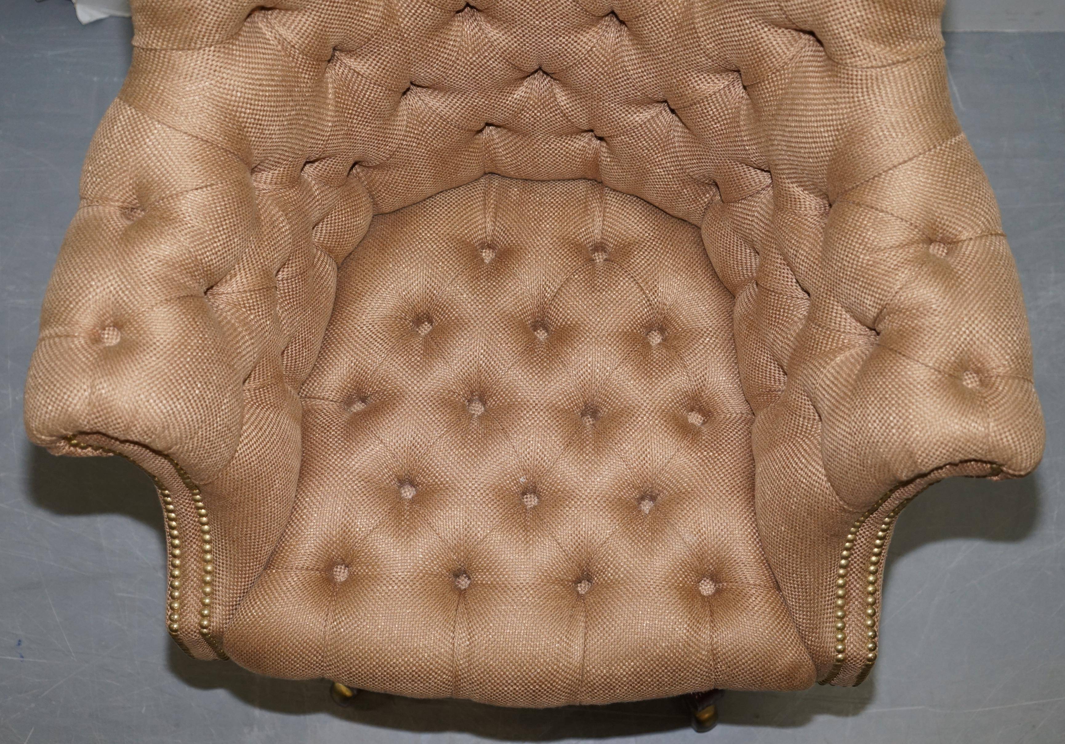 Chesterfield armchair in hardwood, leather, and woven linen.