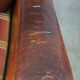 Very large worn sheepskin wing chair with a checked seat cushion
