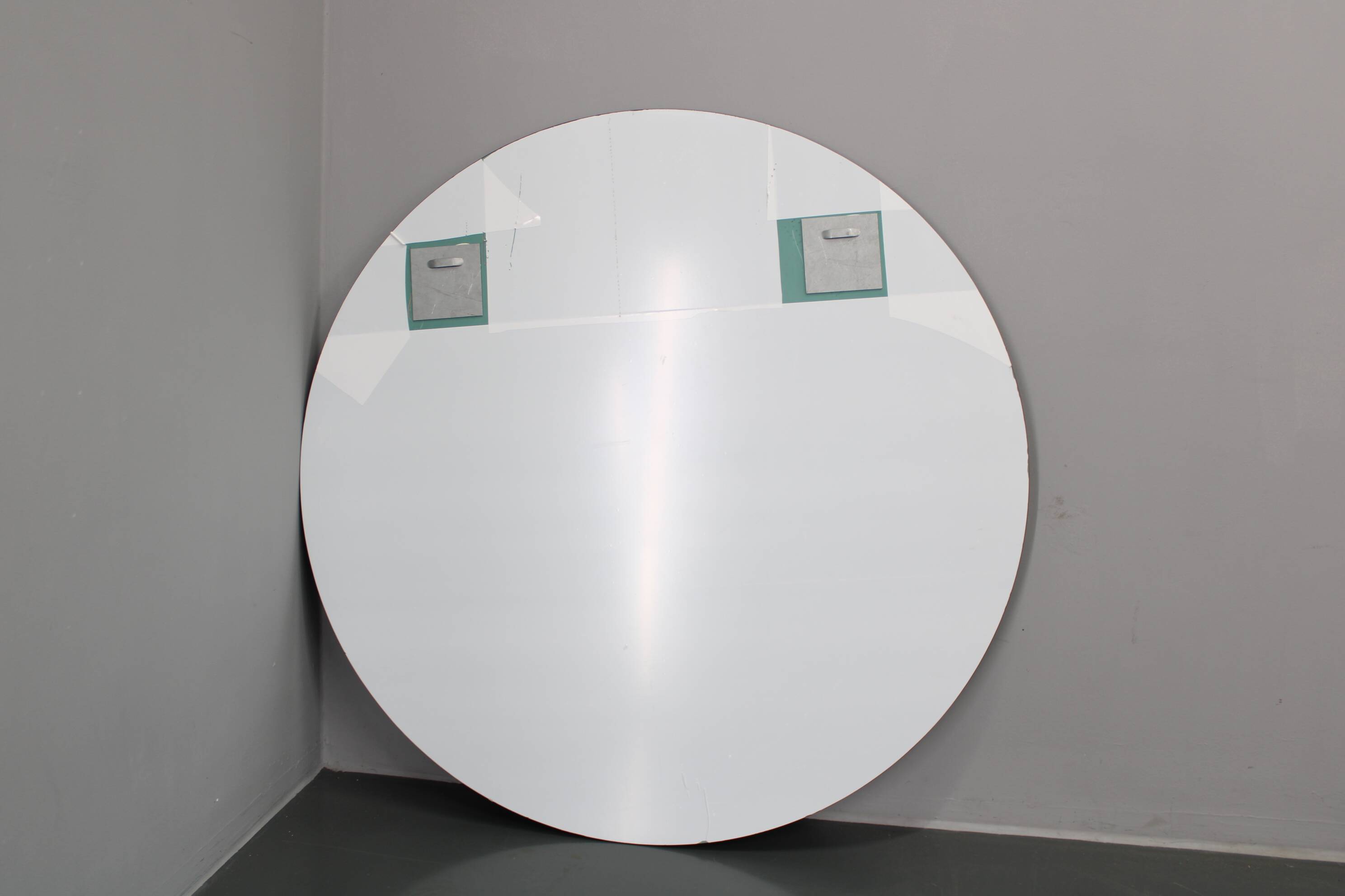 Large 1980s Italian smoke-tinted round mirror with white geometric segment