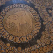 Decorated antique side table with elephant