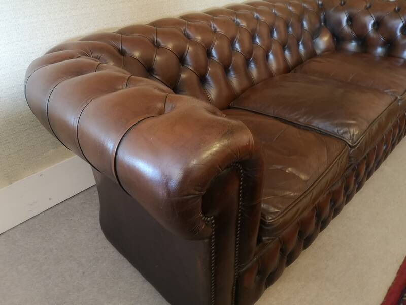 Vintage three-seater brown leather Chesterfield sofa