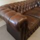 Vintage three-seater brown leather Chesterfield sofa