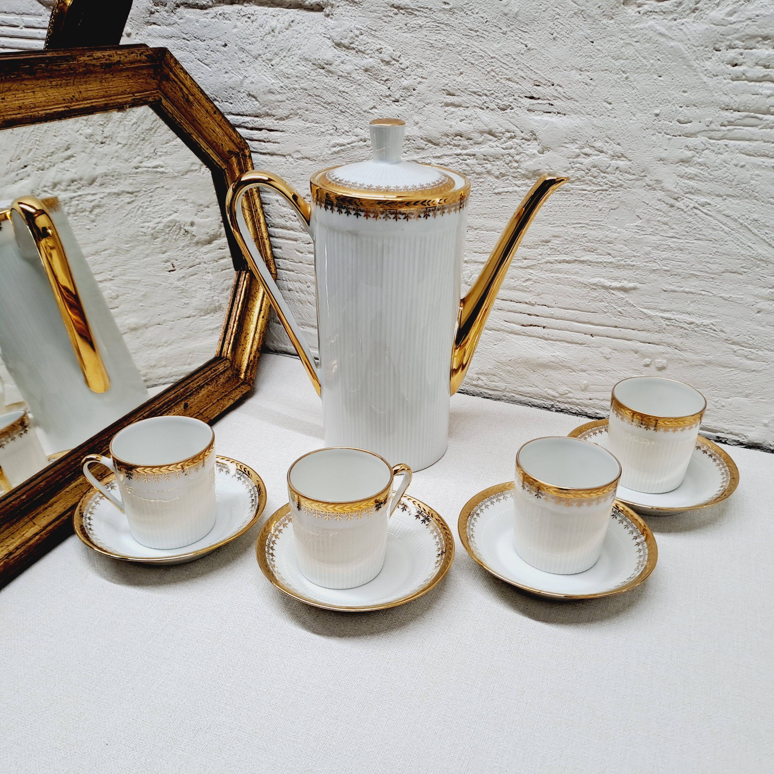 White and gold porcelain coffee maker and cups