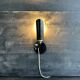 Old black metal and brass wall light, adjustable, 1930s.
