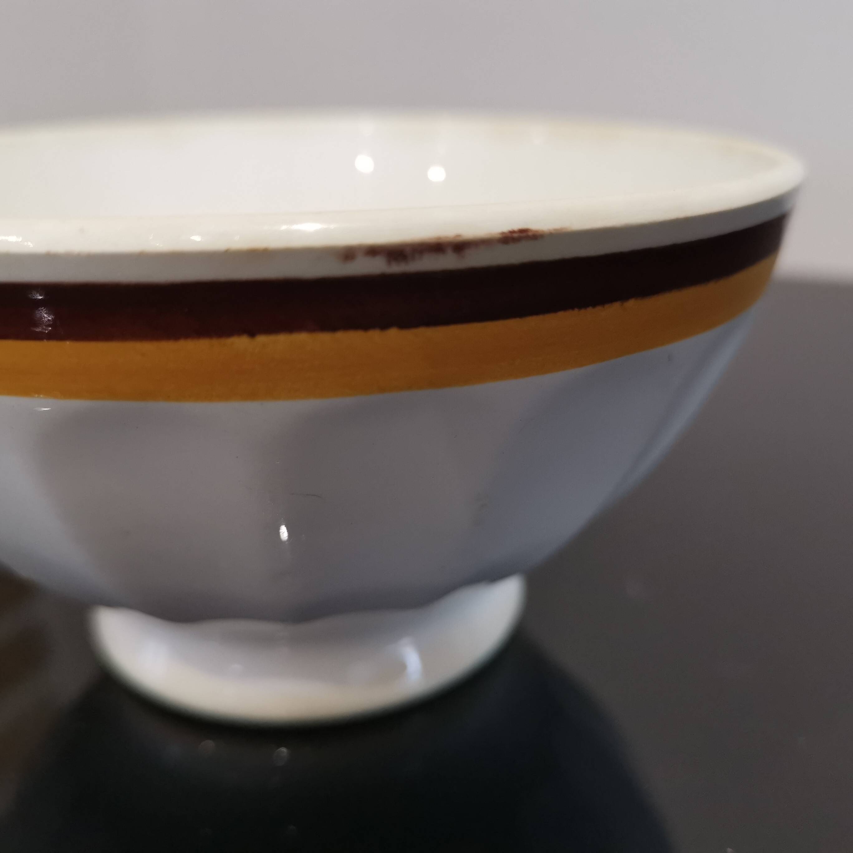 Authentic Vintage ceramic faceted bowl decorated with a double border