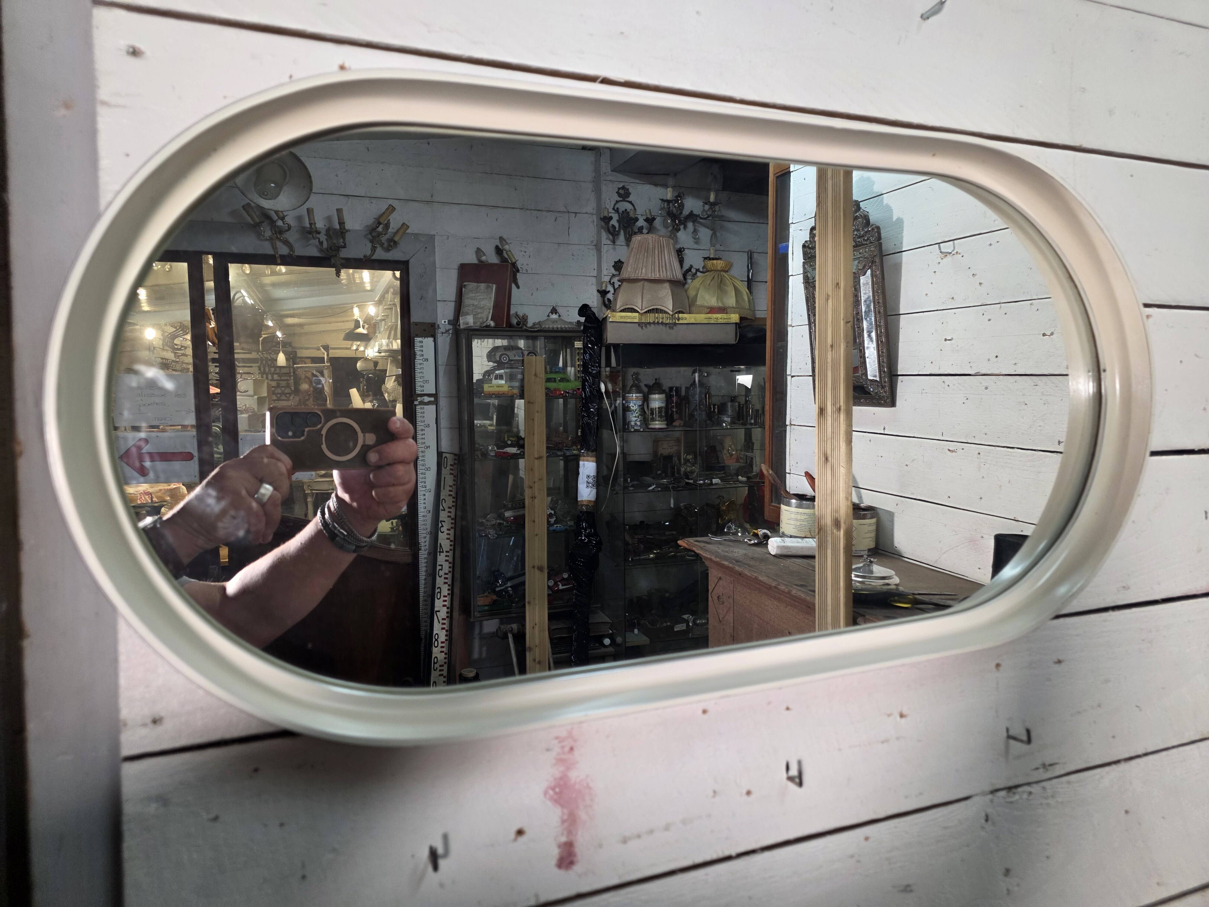 Oval mirror in white lacquer from the 1970s.