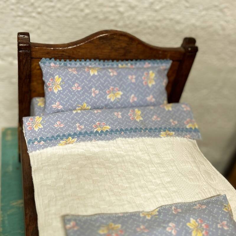 Old doll's bed in varnished wood