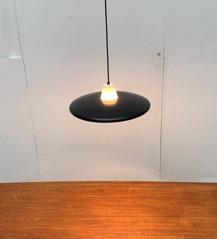 Minimalist metal and glass pendant lamp in mid-century style.